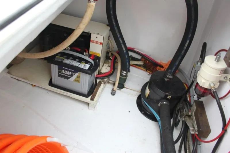 Mangata Yacht Photos Pics Engine compartment of 2003 Lagoon Power 43 with AGM battery and various hoses.