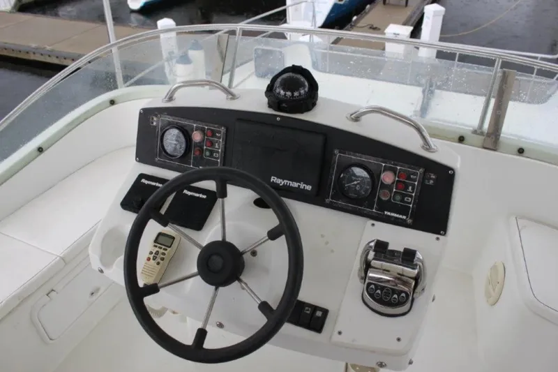 Mangata Yacht Photos Pics Cockpit of 2003 Lagoon Power 43 with steering wheel and navigation instruments.