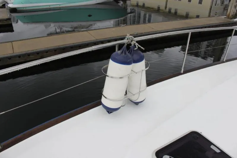 Mangata Yacht Photos Pics Fenders on a 2003 Lagoon Power 43 yacht docked at a marina.