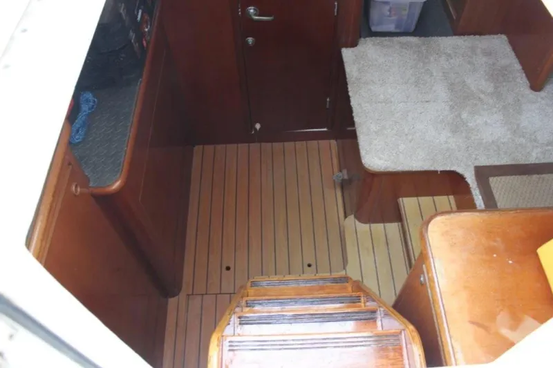 Mangata Yacht Photos Pics Interior view of 2003 Lagoon Power 43 boat with wooden flooring and carpeted area.