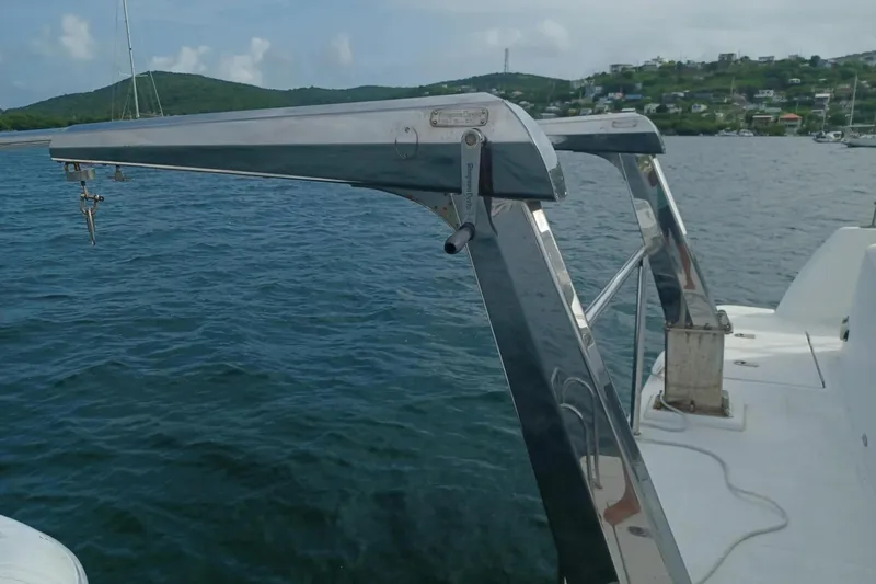 Mangata Yacht Photos Pics 2003 Lagoon Power 43 boat with stainless steel davit system on calm water.