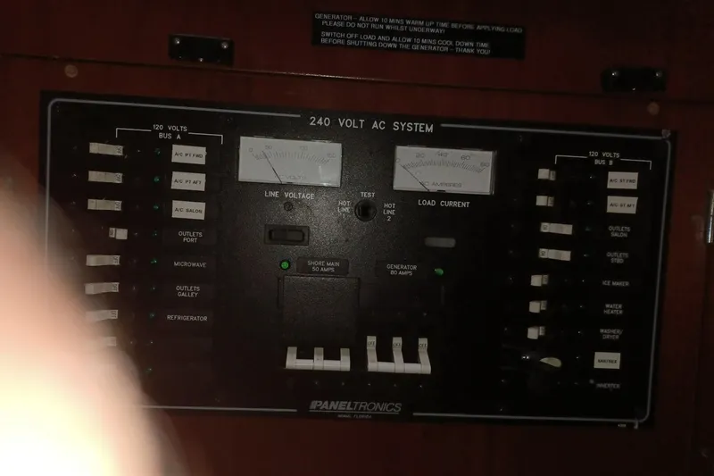 Mangata Yacht Photos Pics Electrical panel of a 2003 Lagoon Power 43 boat, featuring 240-volt AC system controls.