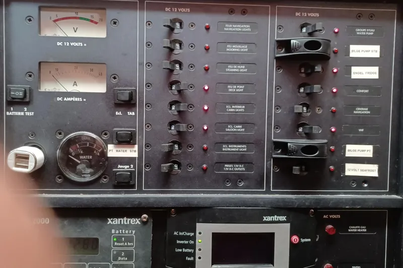 Mangata Yacht Photos Pics Electrical control panel of a 2003 Lagoon Power 43 boat, featuring various switches and gauges.