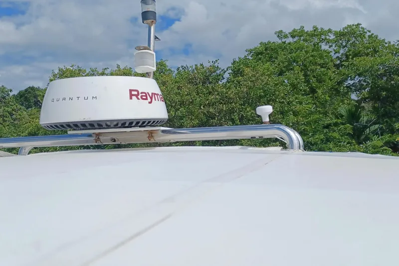Mangata Yacht Photos Pics Radar equipment on a 2003 Lagoon Power 43 boat against a lush green backdrop.