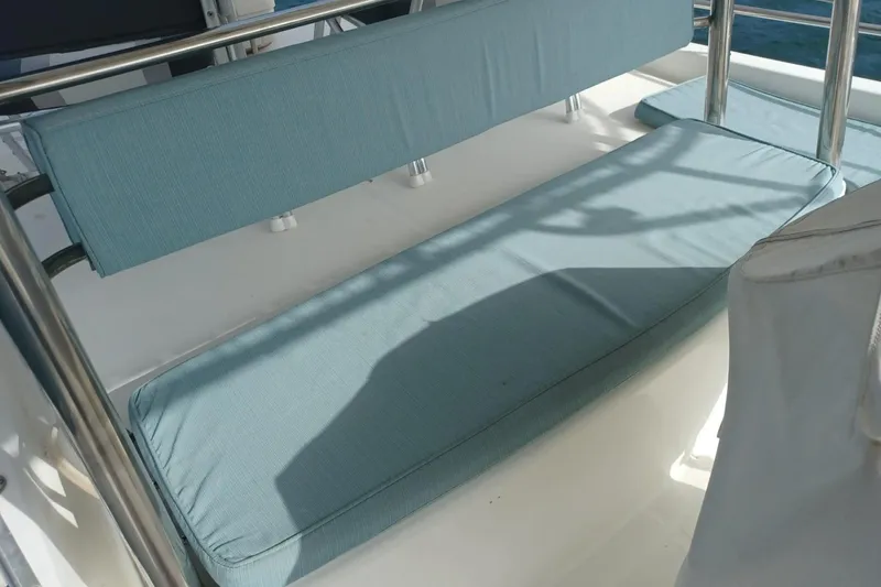 Mangata Yacht Photos Pics Blue cushioned seating on 2003 Lagoon Power 43 yacht deck.