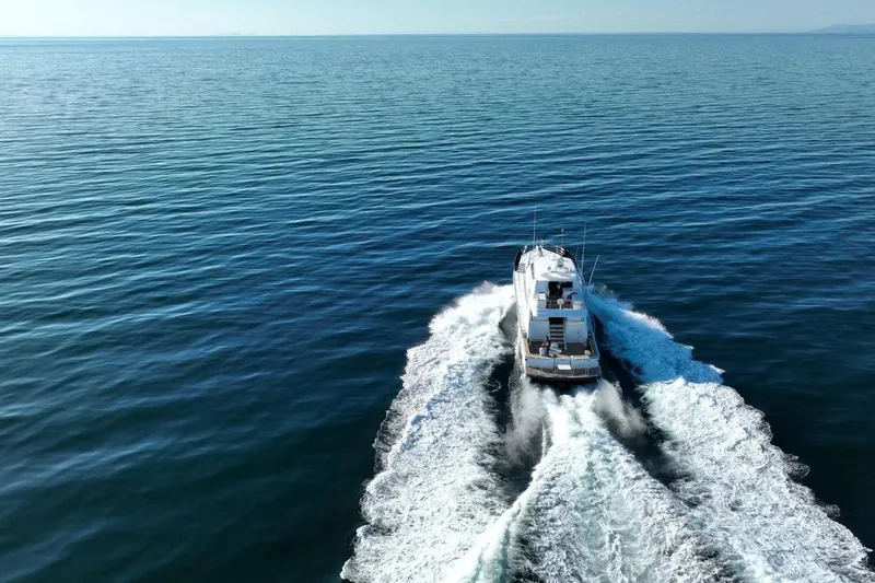 Gramac V Yacht Photos Pics Azzura 76 yacht cruising on open sea, 2007 model, aerial view.