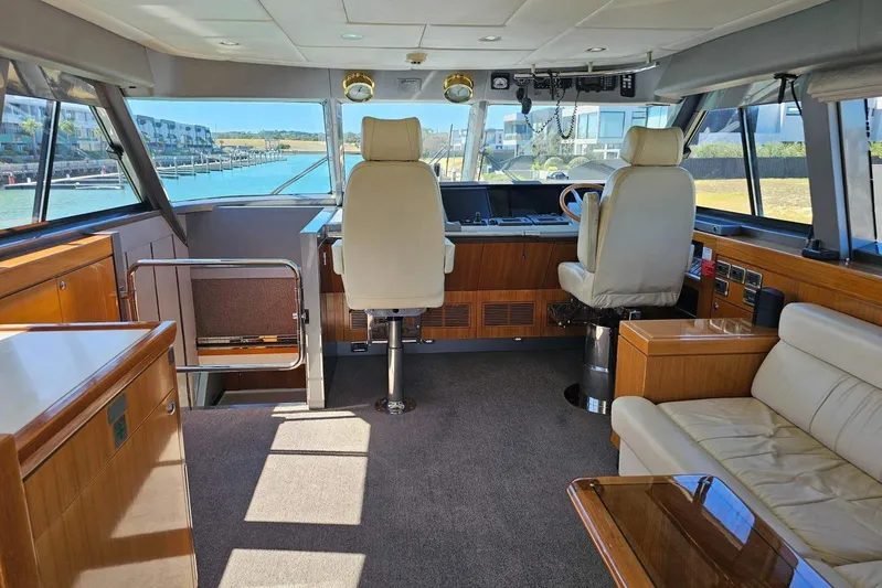 Gramac V Yacht Photos Pics Luxurious interior of a 2007 Azzura 76 yacht with plush seating and panoramic windows.
