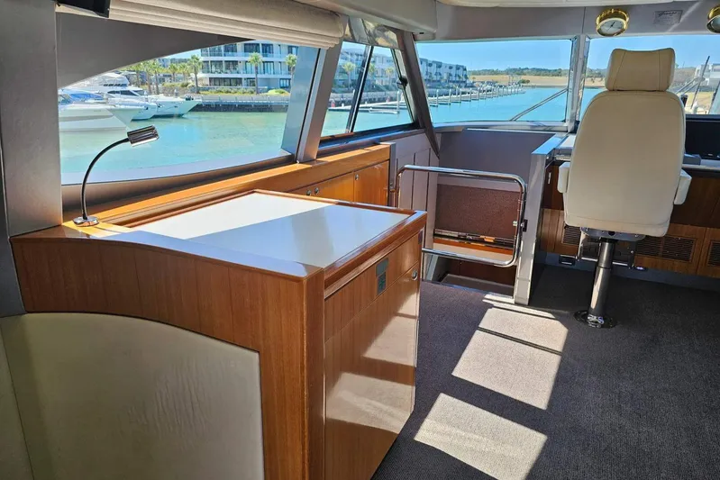 Gramac V Yacht Photos Pics Luxurious interior of a 2007 Azzura 76 yacht with elegant wood finishes and waterfront view.