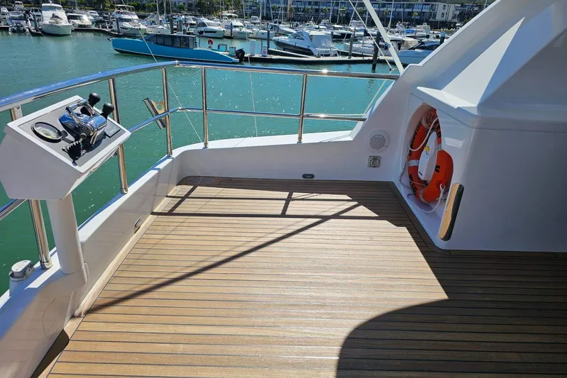 Gramac V Yacht Photos Pics Luxury yacht deck of 2007 Azzura 76, featuring teak flooring and marina view.