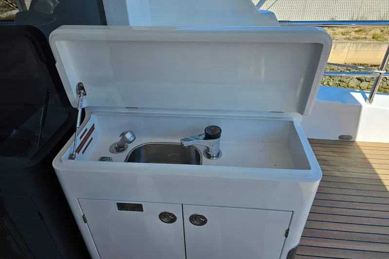 Gramac V Yacht Photos Pics Outdoor sink on 2007 Azzura 76 yacht with wooden deck background.