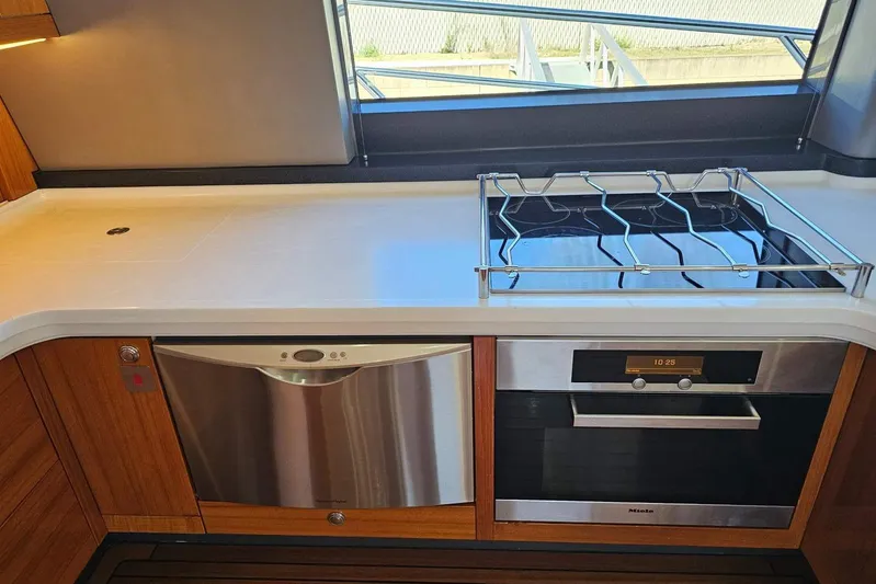 Gramac V Yacht Photos Pics Modern kitchen in 2007 Azzura 76 yacht with stove and dishwasher.