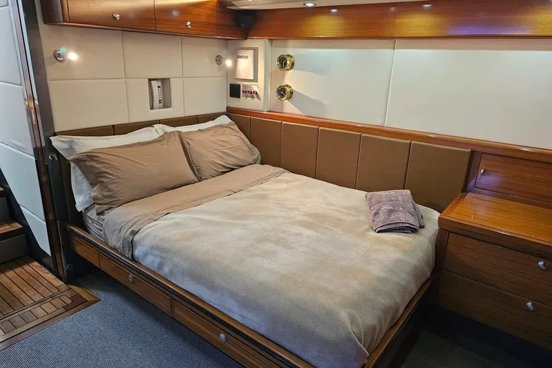 Gramac V Yacht Photos Pics Luxurious bedroom interior of 2007 Azzura 76 yacht with cozy bedding and wooden accents.
