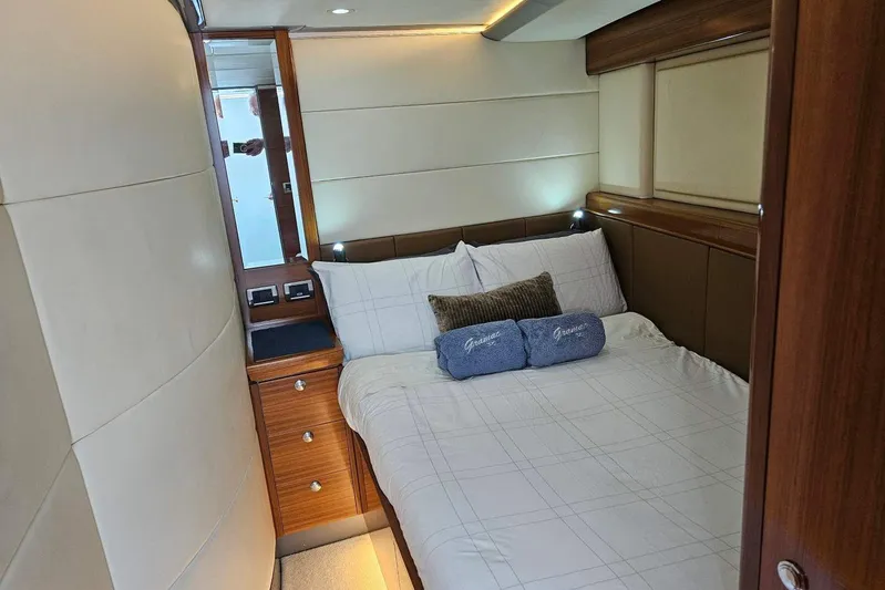 Gramac V Yacht Photos Pics Luxurious bedroom interior of 2007 Azzura 76 yacht with elegant wood accents.