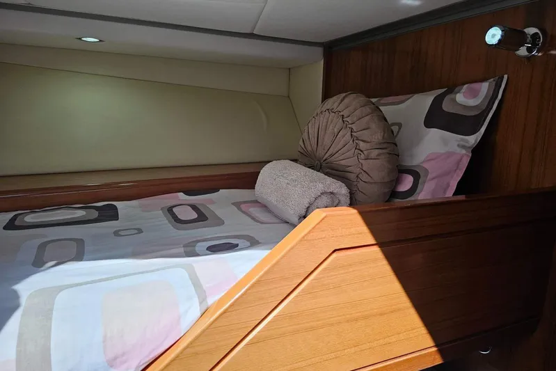 Gramac V Yacht Photos Pics Cozy cabin bed in 2007 Azzura 76 yacht with modern bedding and wooden accents.