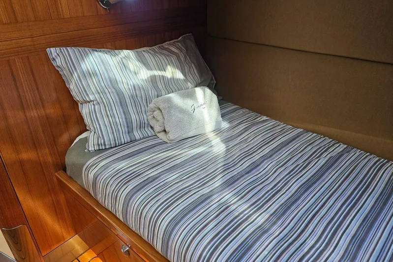 Gramac V Yacht Photos Pics Cozy cabin bed in 2007 Azzura 76 yacht with striped bedding and towel.