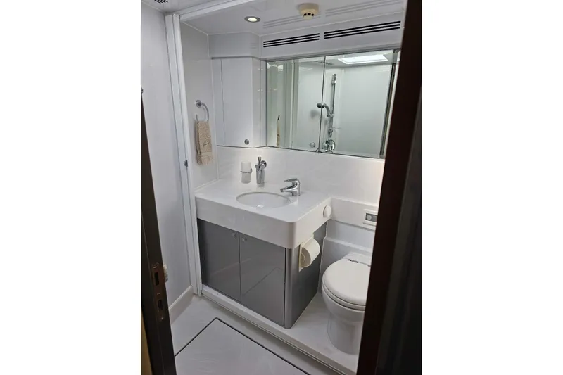 Gramac V Yacht Photos Pics Compact yacht bathroom with modern fixtures, white sink, and mirror in 2007 Azzura 76 model.