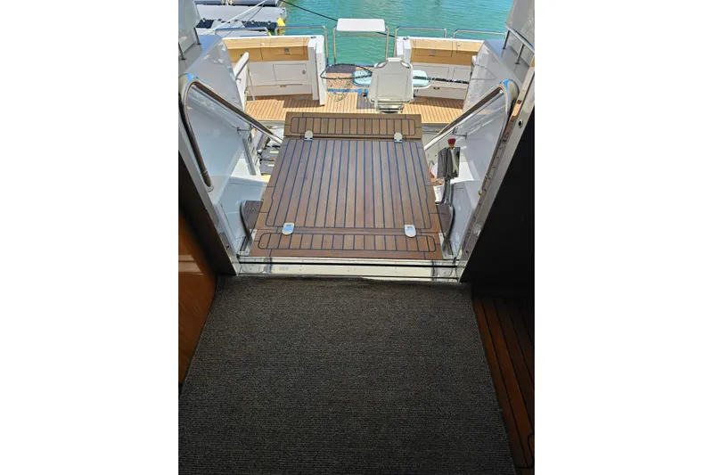 Gramac V Yacht Photos Pics Azzura 76 yacht deck view, 2007 model, featuring wooden flooring and marina backdrop.