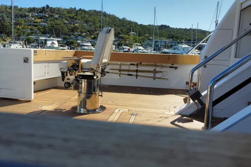 Gramac V Yacht Photos Pics Luxurious 2007 Azzura 76 yacht deck with fishing chair and scenic marina view.