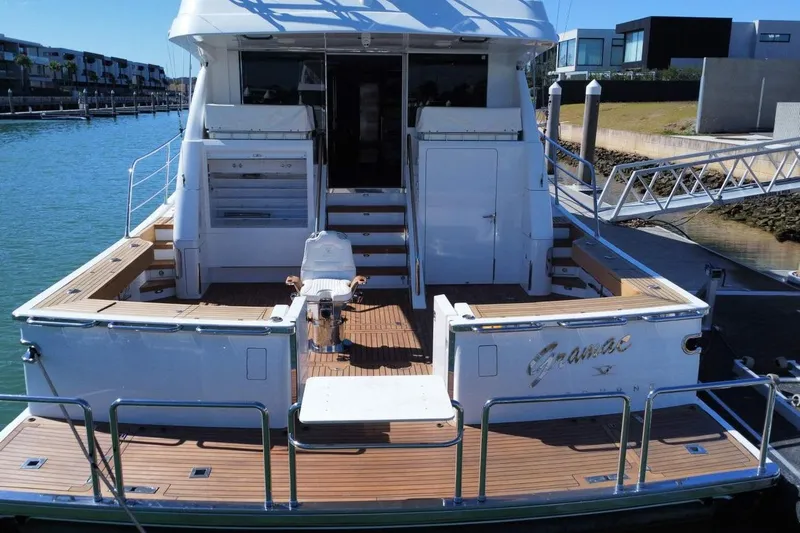 Gramac V Yacht Photos Pics Luxury Azzura 76 yacht from 2007 docked at a marina, featuring spacious deck.