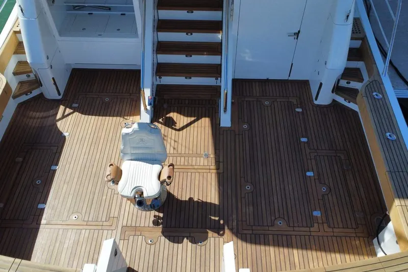 Gramac V Yacht Photos Pics Luxurious 2007 Azzura 76 yacht deck with wooden flooring and central chair.