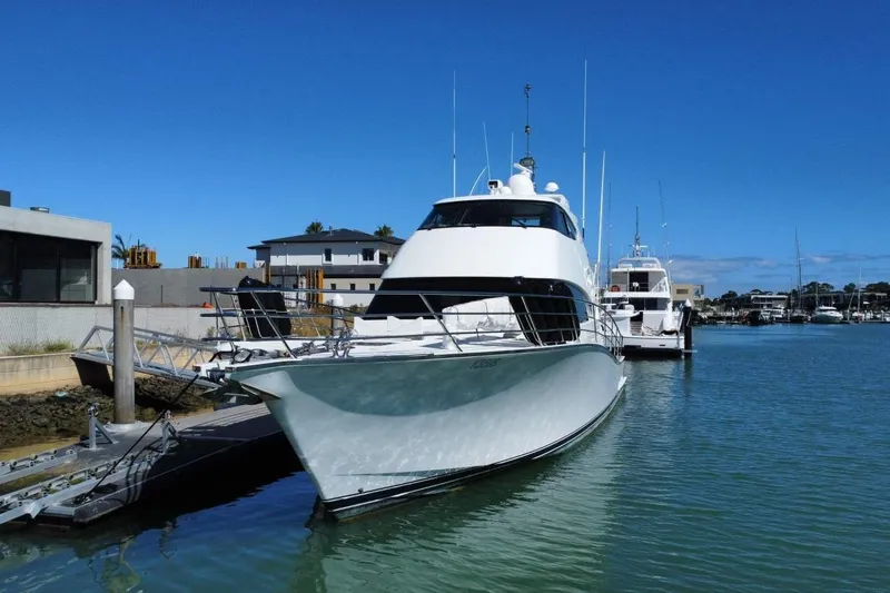 Gramac V Yacht Photos Pics Luxury 2007 Azzura 76 yacht docked in a serene marina setting.