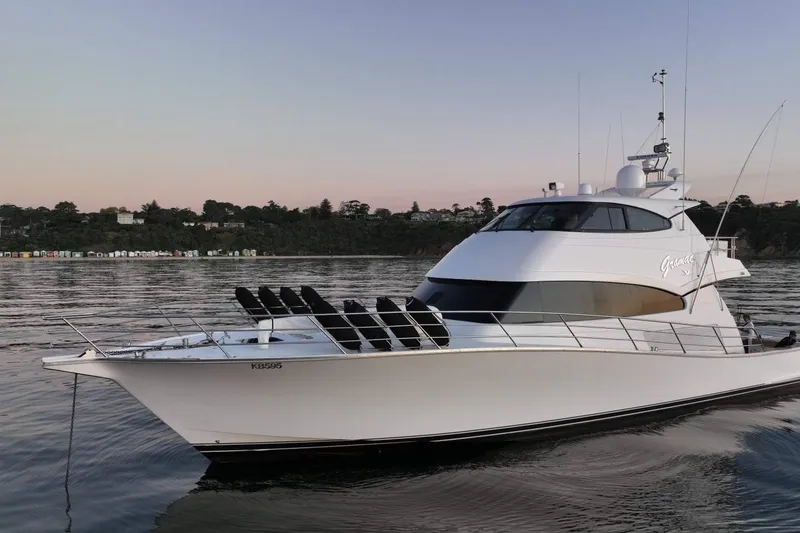 Gramac V Yacht Photos Pics Luxury 2007 Azzura 76 yacht on calm water at sunset, elegant design.