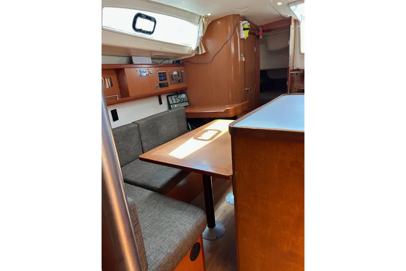 Banyan Sea Yacht Photos Pics Interior of 2008 Beneteau Oceanis 43 yacht with wooden furnishings and seating area.