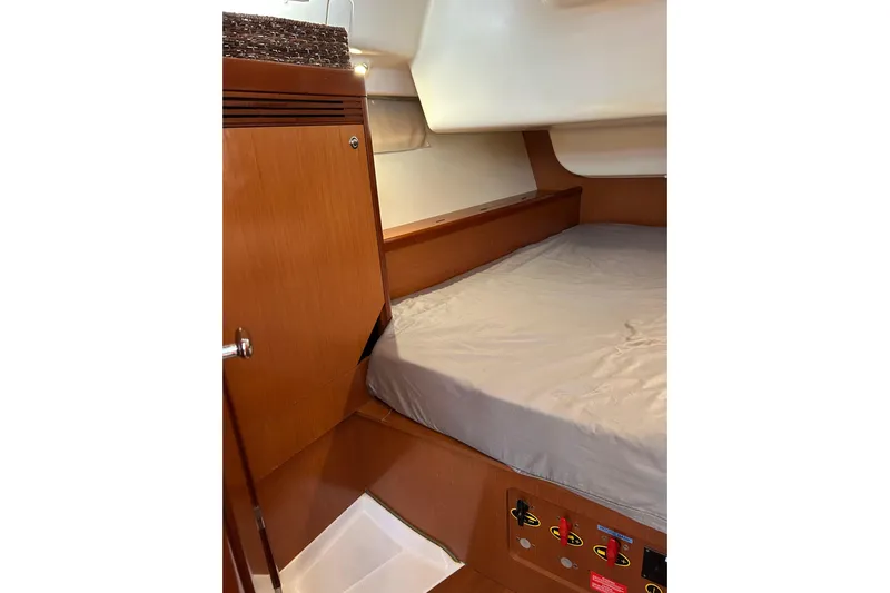 Banyan Sea Yacht Photos Pics Cozy cabin interior of 2008 Beneteau Oceanis 43 sailboat with wooden finish and bed.