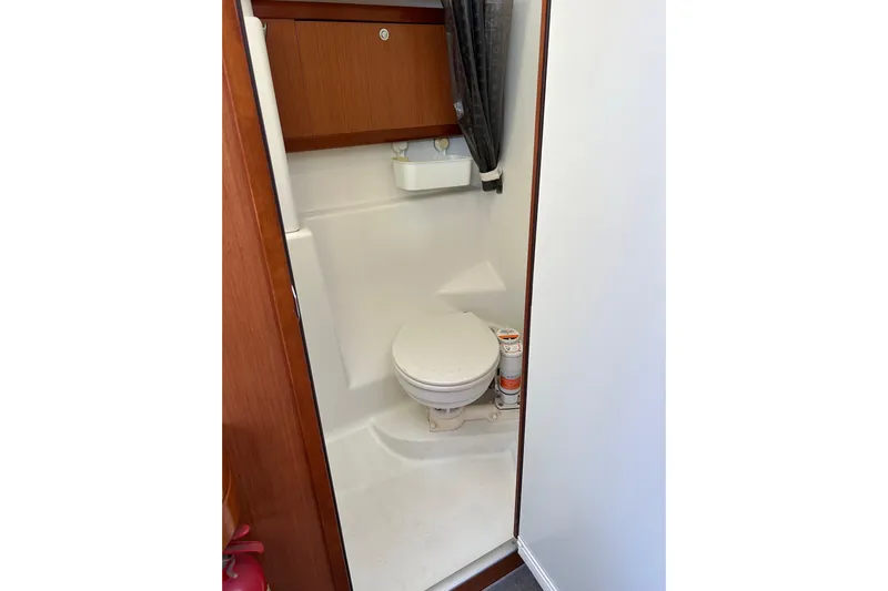 Banyan Sea Yacht Photos Pics Bathroom interior of 2008 Beneteau Oceanis 43 yacht, featuring compact toilet and storage.