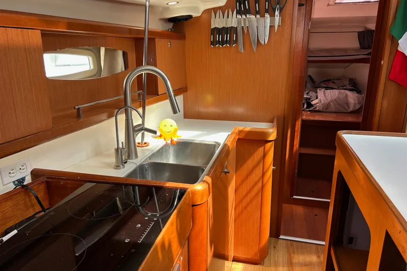 Banyan Sea Yacht Photos Pics Interior of 2008 Beneteau Oceanis 43 yacht kitchen with sink and knives.