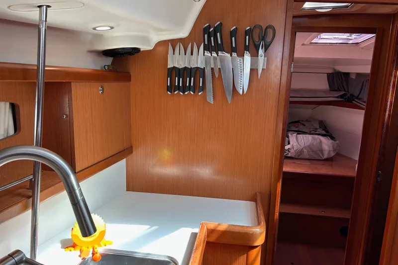 Banyan Sea Yacht Photos Pics Galley of 2008 Beneteau Oceanis 43 yacht with knives and scissors on wall.