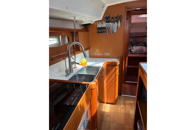 Banyan Sea Yacht Photos Pics Interior of 2008 Beneteau Oceanis 43 yacht kitchen with sink and knife set.