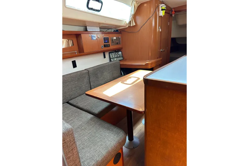 Banyan Sea Yacht Photos Pics Interior of 2008 Beneteau Oceanis 43 yacht with wooden furnishings and seating area.