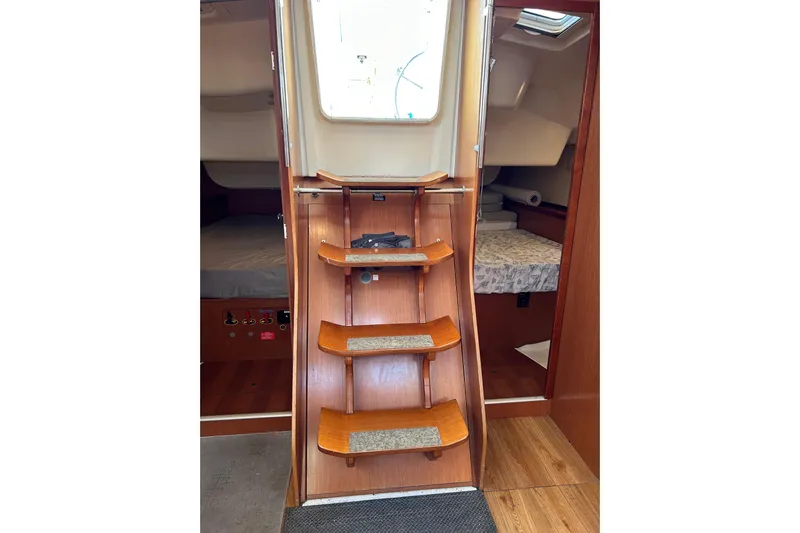 Banyan Sea Yacht Photos Pics Interior view of 2008 Beneteau Oceanis 43 sailboat with wooden steps and cabin access.