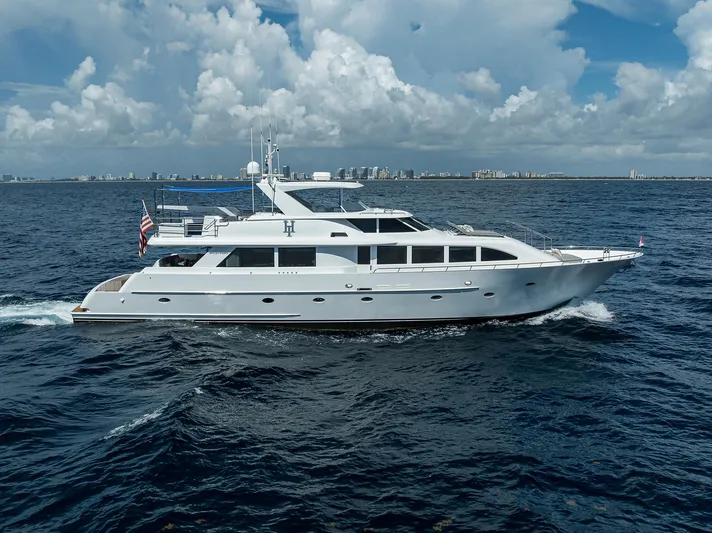 Hard Times Yacht Photos Pics 1998 Westport Westbay Sonship Raised Pilothouse yacht cruising on open sea under cloudy sky.