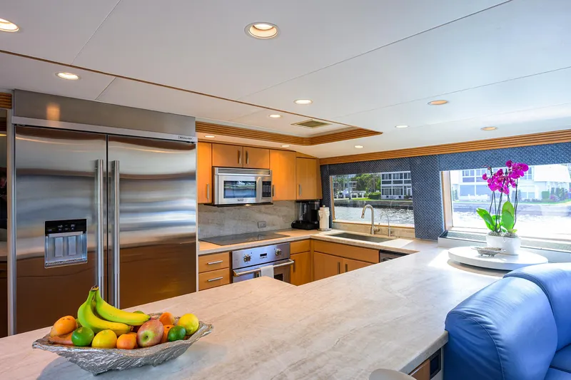 Hard Times Yacht Photos Pics Luxurious yacht kitchen with modern appliances, fruit bowl, and vibrant orchid, Westport Westbay Sonship 1998.