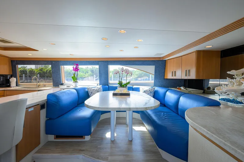 Hard Times Yacht Photos Pics Luxurious 1998 Westport Westbay Sonship yacht interior with blue seating and elegant dining area.