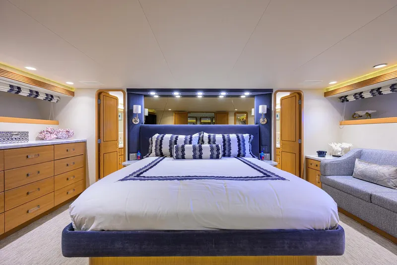 Hard Times Yacht Photos Pics Luxurious bedroom in 1998 Westport Westbay Sonship Raised Pilothouse yacht, featuring elegant decor.