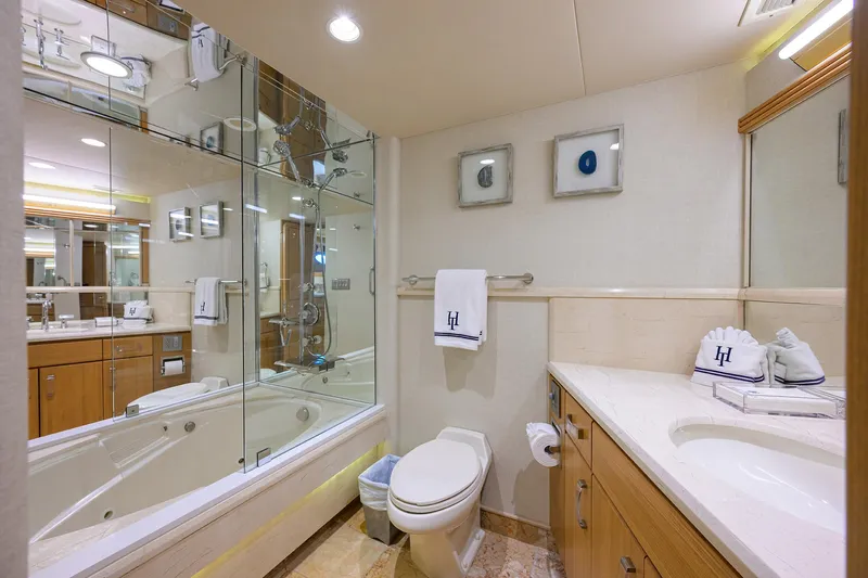 Hard Times Yacht Photos Pics Luxurious yacht bathroom with modern fixtures, glass shower, and elegant decor in 1998 Westport Westbay Sonship.