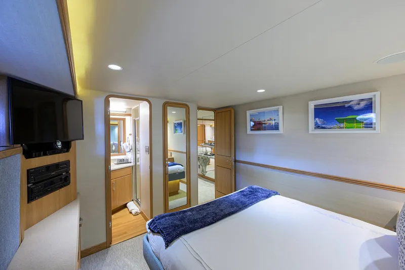 Hard Times Yacht Photos Pics Luxurious bedroom interior of 1998 Westport Westbay Sonship Raised Pilothouse yacht with modern amenities.