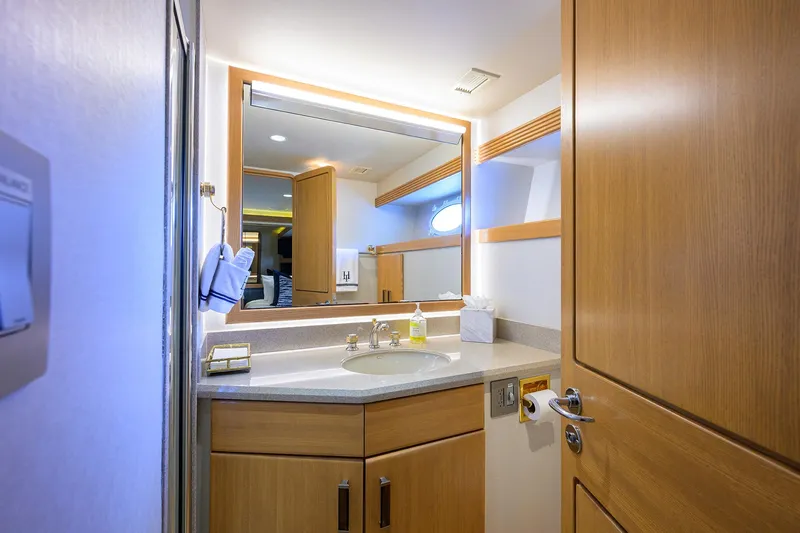 Hard Times Yacht Photos Pics Luxurious bathroom in 1998 Westport Westbay Sonship Raised Pilothouse yacht, featuring wood cabinetry and modern fixtures.