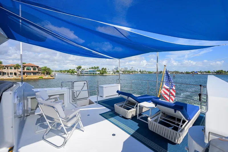 Hard Times Yacht Photos Pics Luxurious 1998 Westport Westbay Sonship yacht deck with sun loungers and blue canopy.