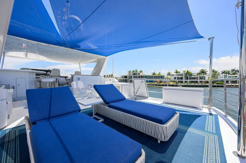 Hard Times Yacht Photos Pics Luxurious 1998 Westport Westbay Sonship yacht deck with blue loungers and canopy.