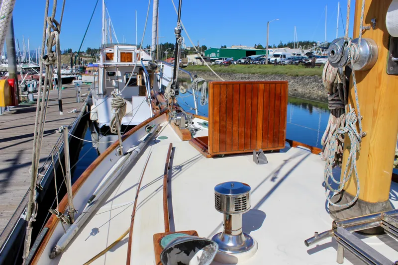 Manu Wai Yacht Photos Pics Sailboat deck view of 1988 Cape George 38 at marina, featuring wooden details and rigging.