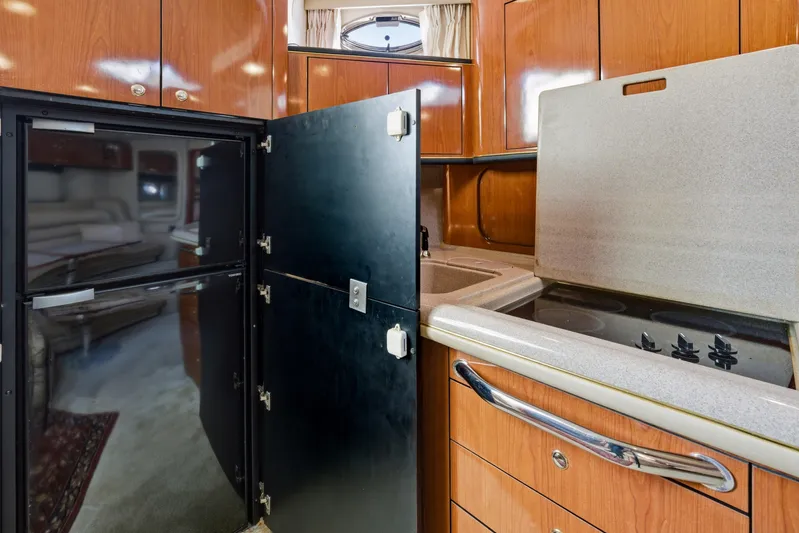 Life Is Good Yacht Photos Pics 2002 Sea Ray 460 Sundancer yacht kitchen with wood cabinets and modern appliances.