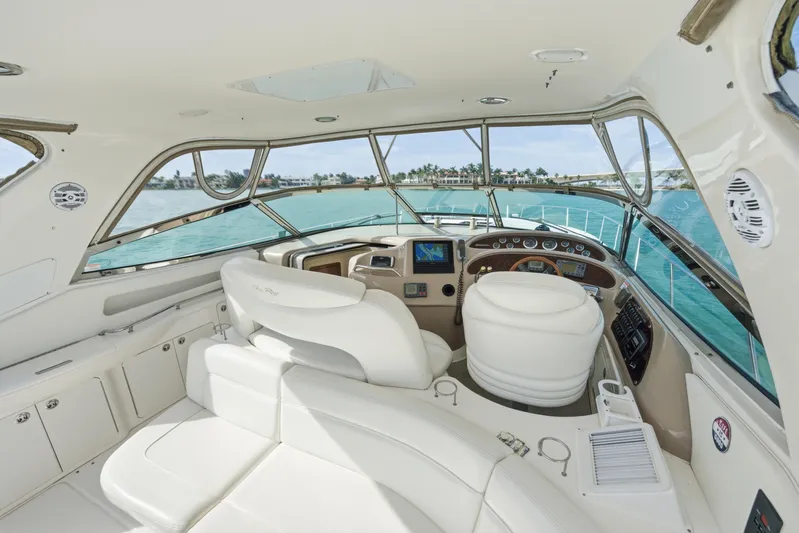 Life Is Good Yacht Photos Pics Luxurious 2002 Sea Ray 460 Sundancer yacht interior with helm and seating, overlooking turquoise waters.
