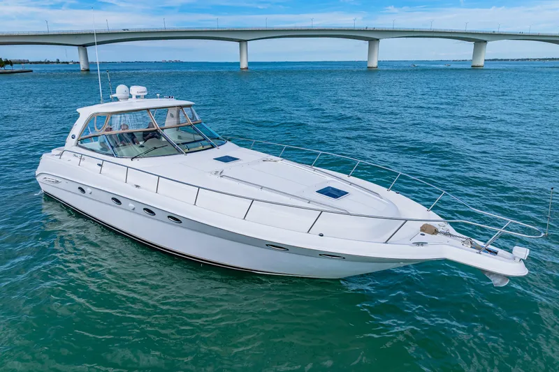 Life Is Good Yacht Photos Pics 2002 Sea Ray 460 Sundancer yacht cruising under a bridge on a sunny day.