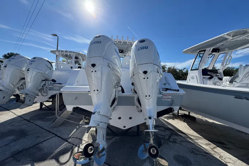  Yacht Photos Pics 2026 Sportsman Open 262 Center Console with twin outboard engines under sunny sky.