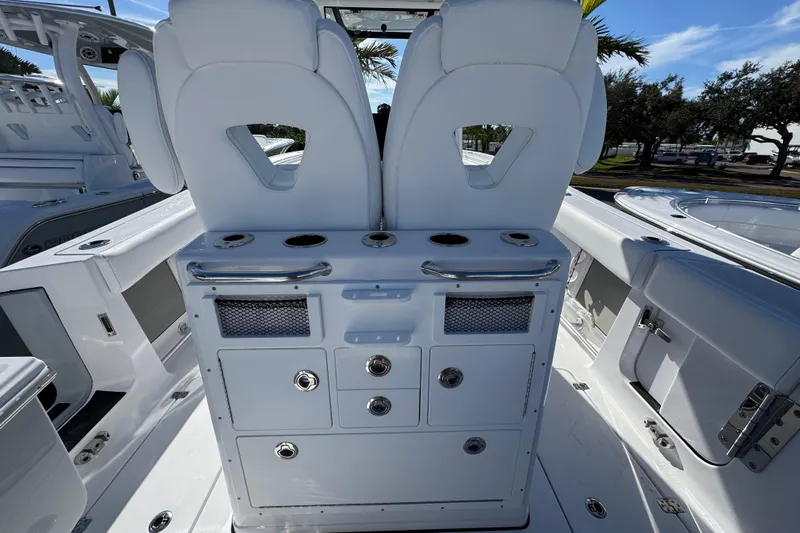  Yacht Photos Pics 2026 Sportsman Open 262 Center Console boat interior with white seating and storage compartments.