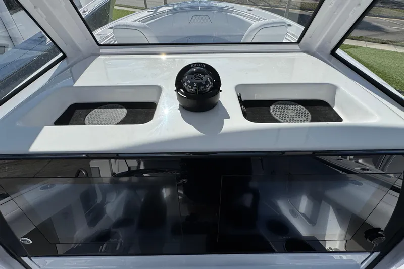  Yacht Photos Pics 2026 Sportsman Open 262 Center Console boat dashboard with compass and storage compartments.